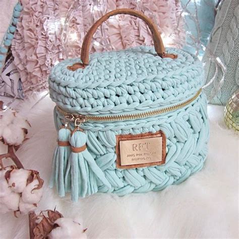 A Blue Purse Sitting On Top Of A White Blanket