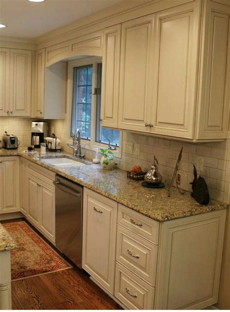 A bright white kitchen cabinet and a dark granite countertop can create a really dramatic look with a nice sense of contrast. White cabinets, subway tile, beige granite countertops ...
