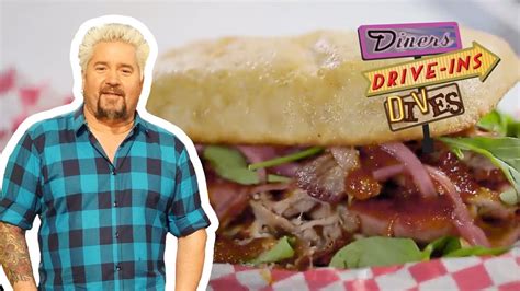 guy fieri eats a pork brisket and sausage sandwich diners drive ins and dives food network
