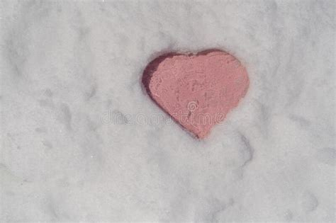 Pink Heart Shape On A White Fresh Snow In Winter Close Up Stock Photo