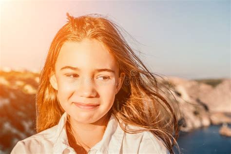 adorable teenage girl outdoors enjoying sunset at beach on summer day close up portrait of