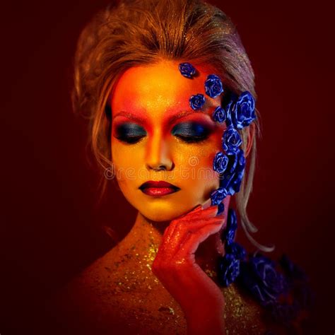 Portrait Of Young And Attractive Woman With Art Makeup Fiery Colors