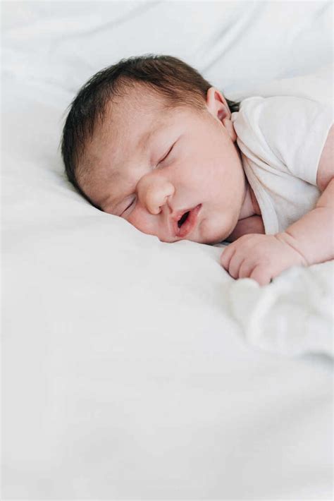 Cute Newborn Baby Girl Sleeping On Bed In Hospital Stock Photo