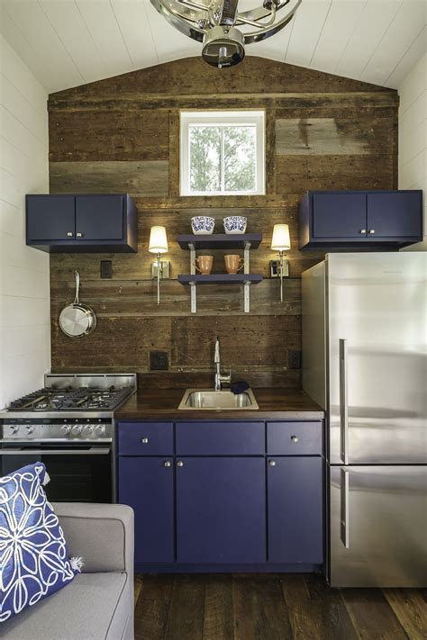 Kitchen With Blue Cabinets And Stainless Appliances In A Tiny House