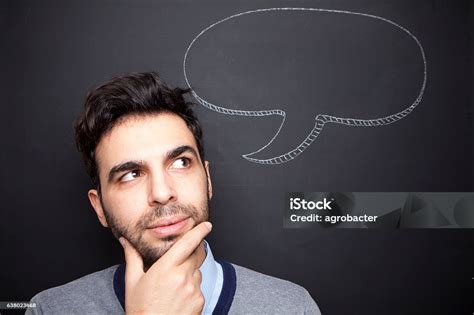 Man Thinking Hard In Front Of Chalkboard Stock Photo Download Image