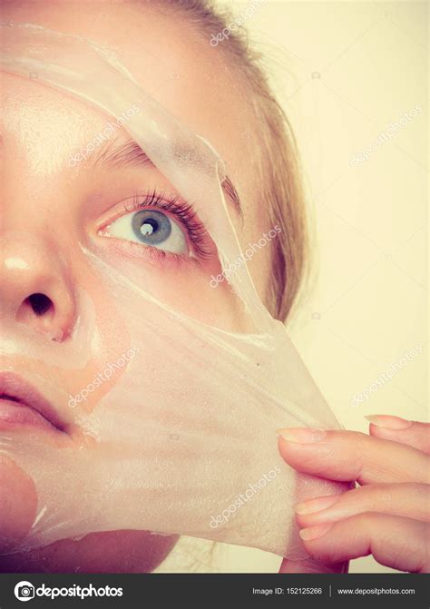 Woman Removing Facial Peel Off Mask Stock Photo By ©voyagerix 152125266