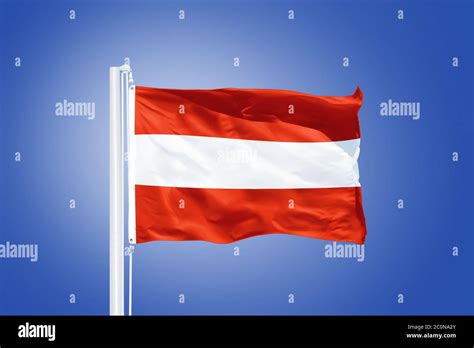 Flag Of Austria Flying Against A Blue Sky Stock Photo Alamy