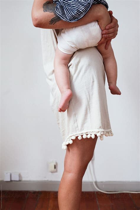 Woman Holding A Baby On Her Hip By Stocksy Contributor Pink House