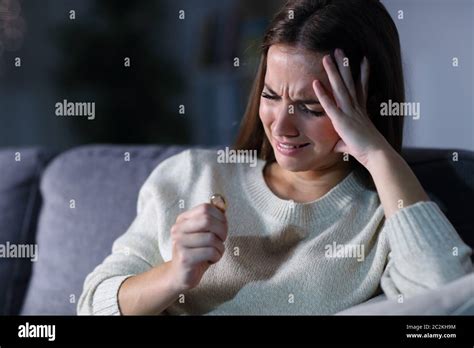Sad Girl Complaining Looking At Wedding Ring After Divorce Sitting On A