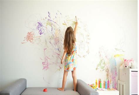 Anime woman wearing crop top and red shorts leaning on wall wallpaper. Feature-draw on the wall