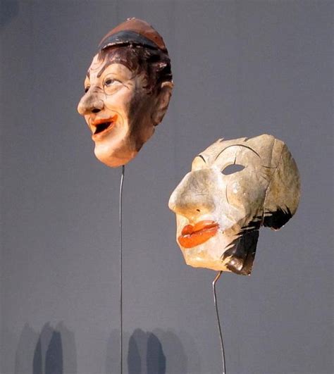 Two Masks That Look Like They Are Wearing Heads With Mouths Open And