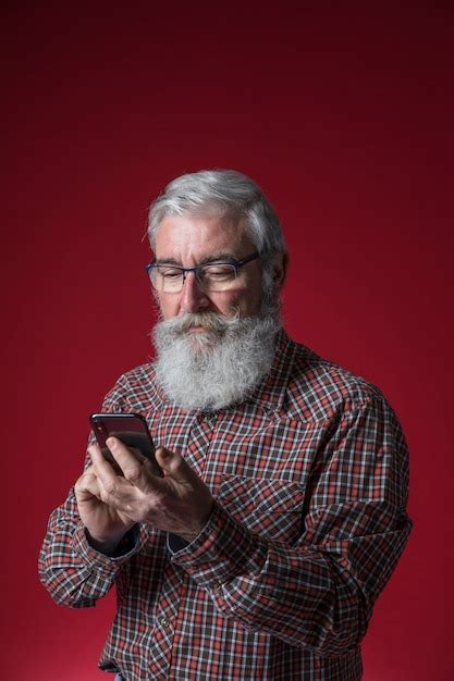 Free Photo Close Up Of A Senior Man With Grey Beard Using The Mobile
