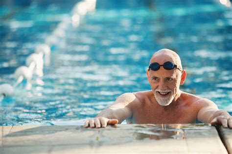 Active Older Man Working Out In Outdoor Swimming Pool By Stocksy