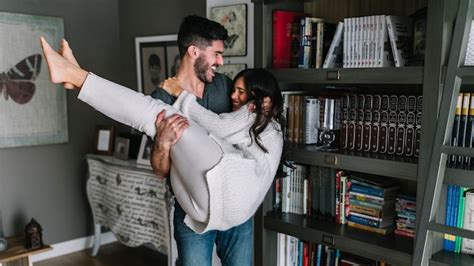 Free Photo Smiling Young Man Carrying Her Girlfriend In Living Room