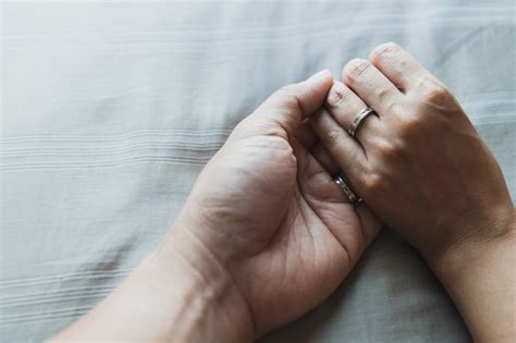 Premium Photo Close Up Husband And Wife Hands Together On Gray Beds And Beautiful Wedding Rings
