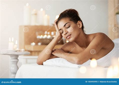 Beautiful African Girl Resting Relaxing In Spa Salon With Closed Eyes