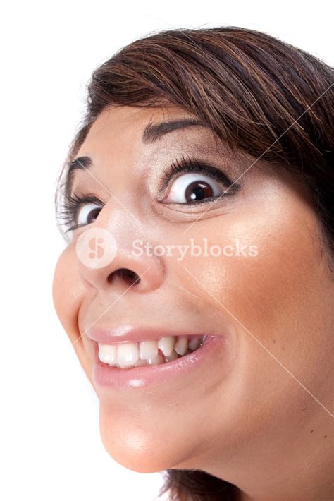 Woman With A Funny Look On Her Face Smiles Over A White Background Royalty Free Stock Image