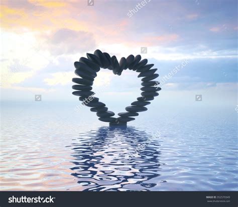 Stock Photo Black Zen Stones In A Heart Shaped Form In The Sunset
