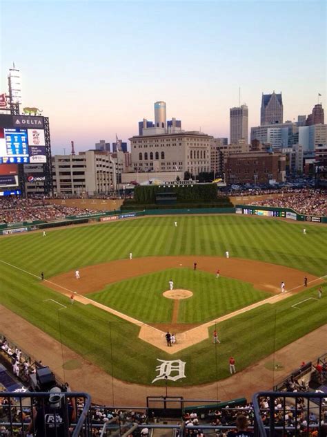 A Baseball Game Is Being Played In A Stadium With The City Skyline In