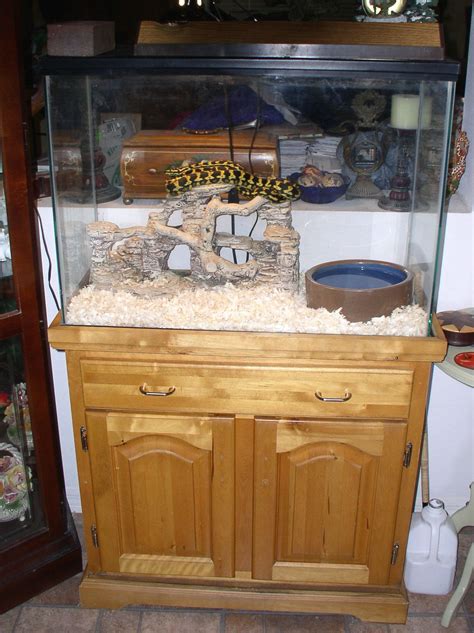 A Fish Tank Sitting On Top Of A Wooden Cabinet