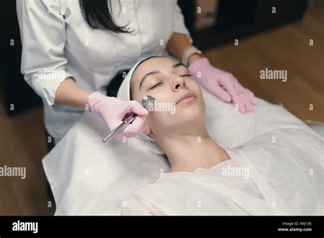 Model With Closed Eyes And Hands Of Doctor Rejuvenating Facial Treatment Model Getting