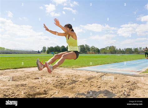 Woman Doing Long Jump Stock Photo Alamy