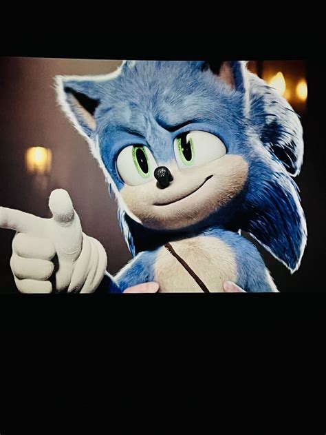 An Animated Image Of Sonic The Hedgehog Pointing At Something In Front