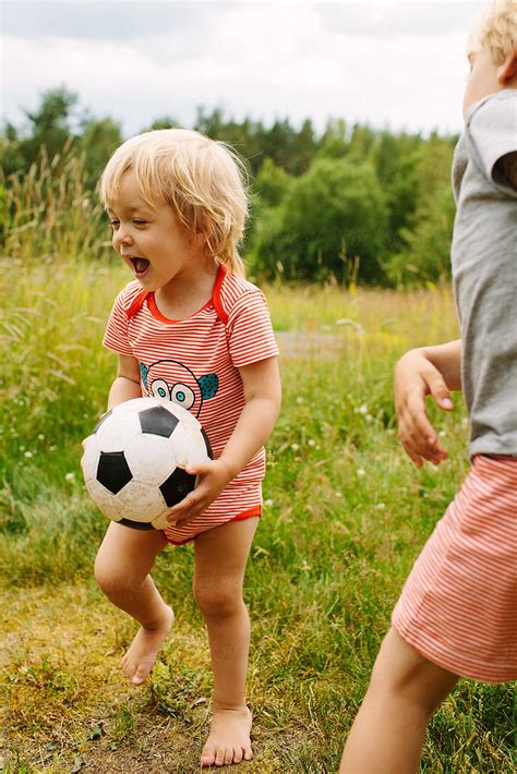 Babe Girl With Bare Feet Plays Ball With Her Brother By Julia Forsman