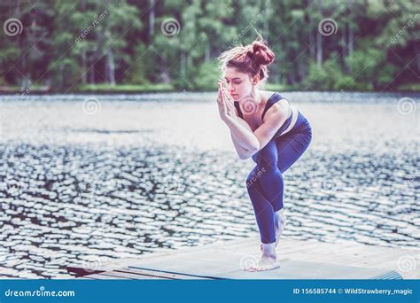 Yogi Girl Practicing Yoga Standing In Eagle Pose Garudasana Exercise