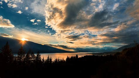 Download Wallpaper 1366x768 Mountains Lake Sunset Horizon Clouds