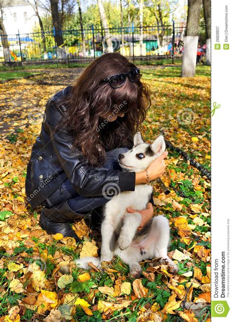Young Woman And Small Dog Siberian Husky Stock Image