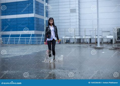 Soaked In The Rain The Girl Jumps In A Puddle Stock Photo Image Of