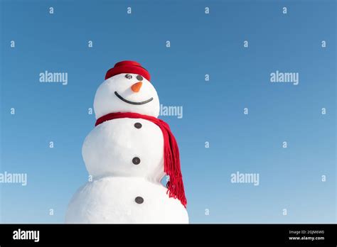 Funny Snowman In Stylish Red Hat And Red Scalf On Snowy Field Blue Sky