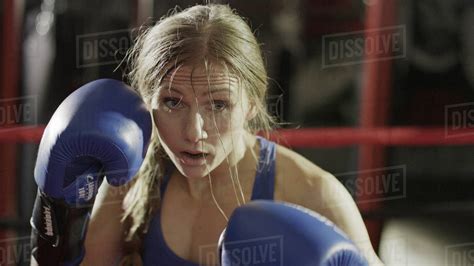 Close Up Of Female Boxer In Boxing Gloves Standing In Boxing Ring During Match Stock Photo