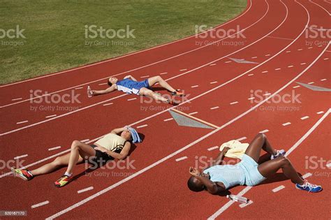 Exhausted Runners On Track Stock Photo Download Image Now Running