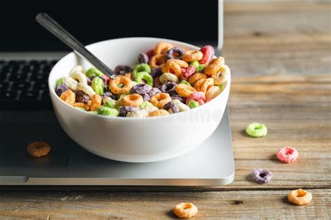 Colored Breakfast Cereals In A Bowl And Laptop Healthy Breakfast Close