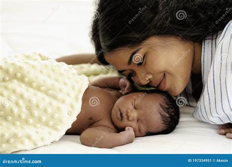 African American Infant Baby Lying On Bed With Mother Watching Beside