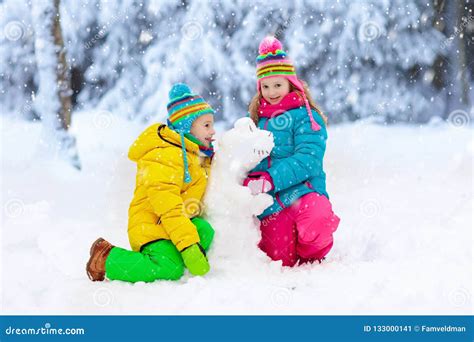 Kids Making Winter Snowman Children Play In Snow Stock Image Image