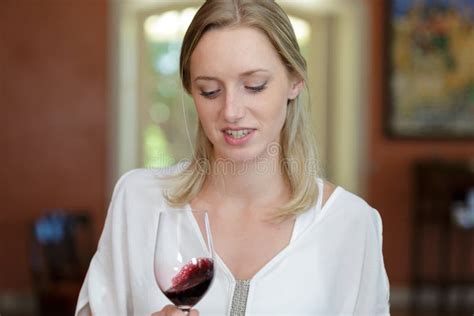 Young Oenologist Looking At Red Wine In Glass Stock Photo Image Of