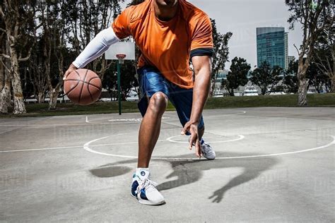 Young Man Playing Basketball On Court Close Up Stock Photo Dissolve