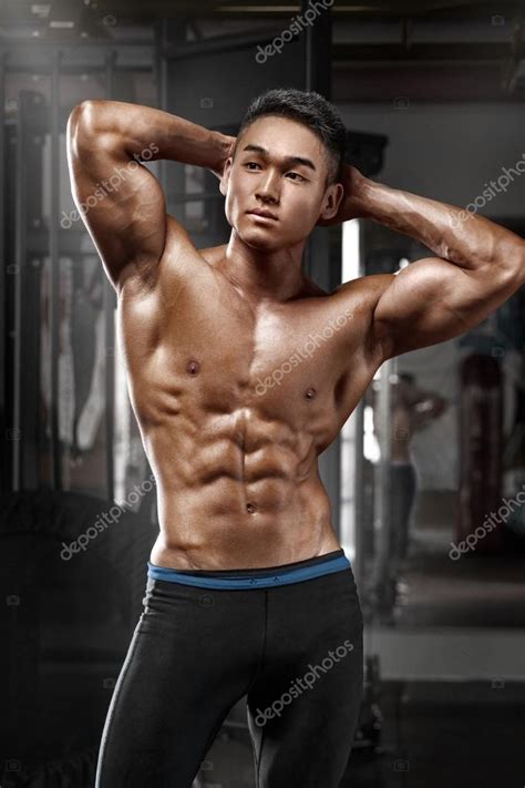 sexy asian muscular man posing in gym shaped abdominal strong male naked torso abs working