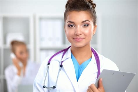 Premium Photo Portrait Of Young Woman Doctor With White Coat Standing