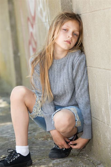 Sad Girl Sitting Against The Wall Royalty Free Stock Photo Image