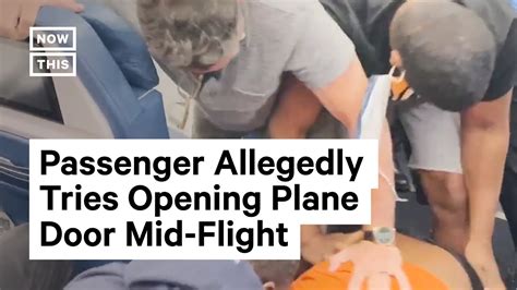 unruly passenger allegedly tries to open plane door mid flight youtube