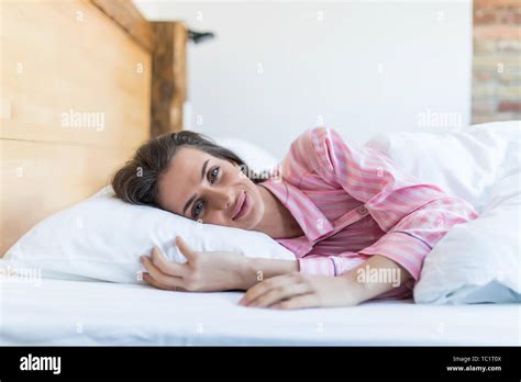 Young Woman Sleeping In Her Bed And Relaxing In The Morning Stock Photo