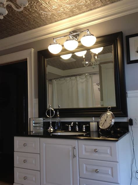 The kitchen features white cabinets, black countertops, black hardware, matte black faucet, black sink, countertop paint and peel and stick tile! White cabinet with black counter top, nickle finishes and ...