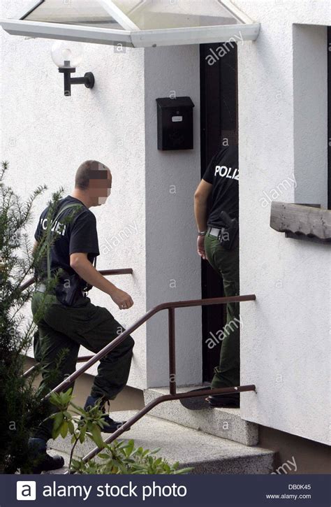 Investigators Carry Bags And Boxes Out Of The House Of The Terror Suspects In Oberschledorn