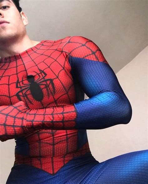 A Man In A Spiderman Costume Poses For The Camera With His Hands On His