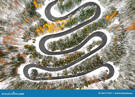 Aerial View Of Car On Winding Road In Snowy Winter Forest Stock Image
