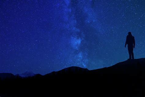 Star Gazing At Night Silhouette In Mountains Photograph By Cavan Images